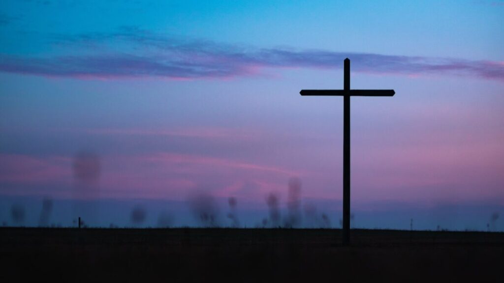 cross stand under purple and blue sky
