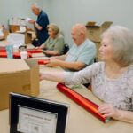 Cottage Hill members wrap presents for UM graduating class