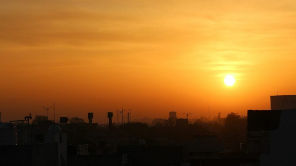 silhouette of city buildings during sunset