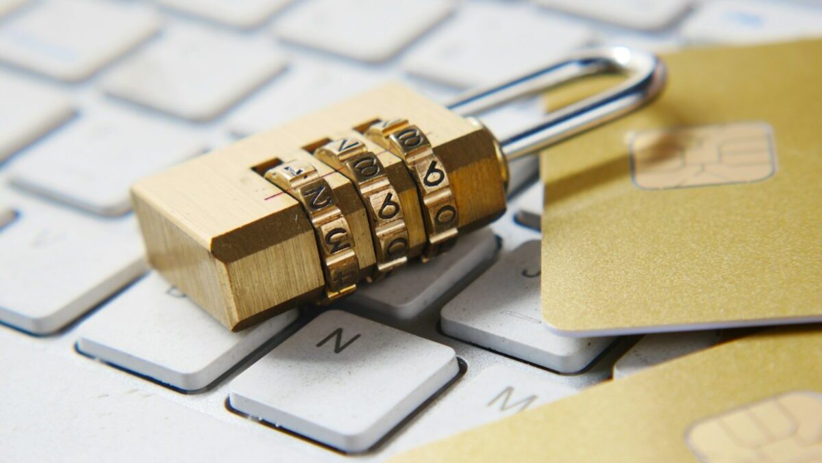 a golden padlock sitting on top of a keyboard