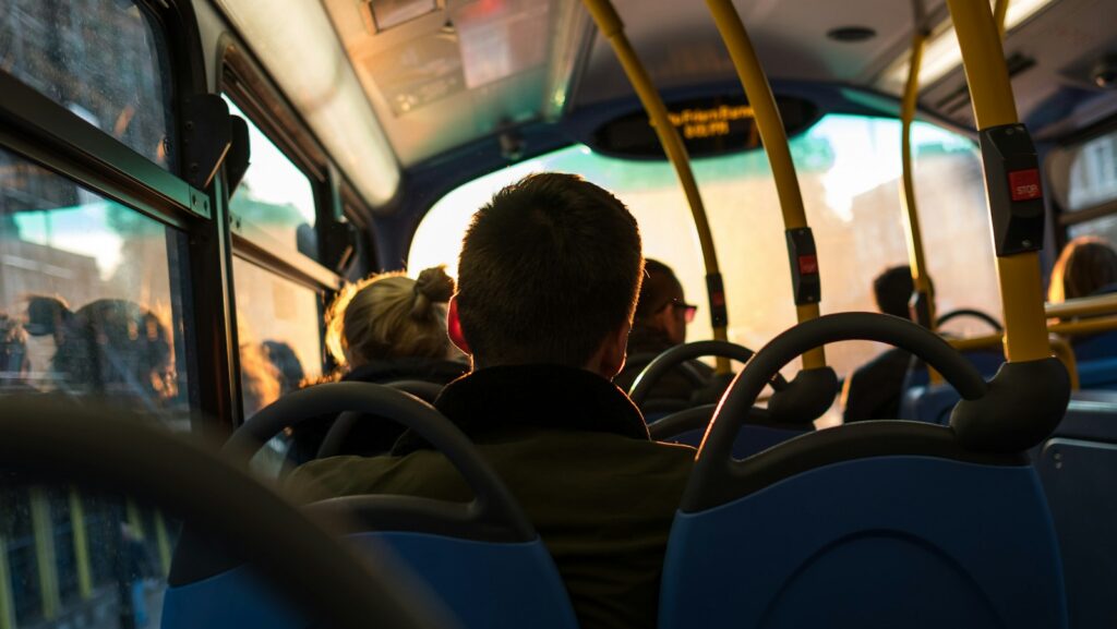 photo of man sitting inside bus