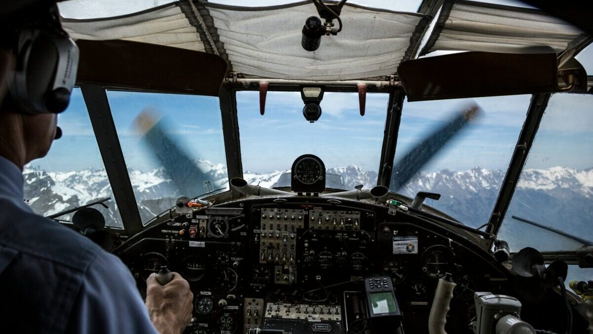 pilot driving plane during daytime