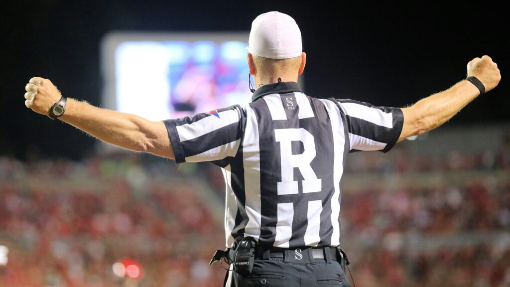 a referee in a black and white striped uniform
