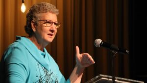 Sandy Wisdom-Martin at podium