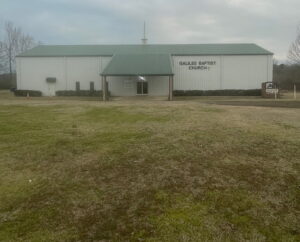 Church building and front lawn during morning hours