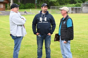 Three men talking near Liberty Church in Craig, Alaska (Scotty Goldman, Cody Schwegel and Jamie Baldwin)